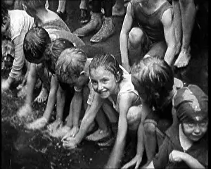 Heatwave: Children Splashing In Water in the Gutter During