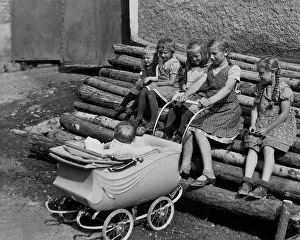 Logs: Children on a stack of logs, 1937
