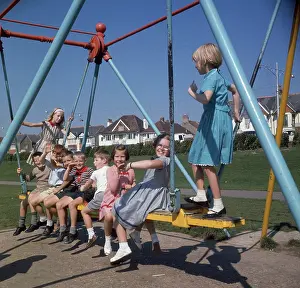 Swings: Children on a swing in a park