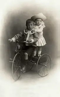 Sibling: Children on a tricycle