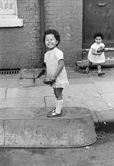 Upturned: Two children with upturned tin bath