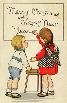 Writes: Children writing ?Merry Christmas? on a board