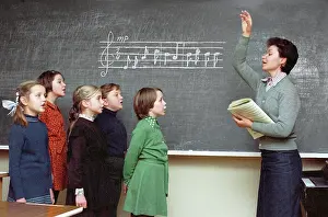 Conducts: Children's choir during lesson, 1982
