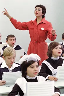 Conducts: Children's choir during lesson, 1982