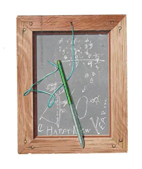Oeil: Child's slate with pen and scribbles on a New Year card