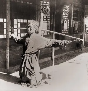 Mukden: Chinese prisoner kneeling on chains, with ?