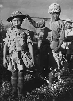Lcgr1312: Chinese soldier, age 10, with heavy pack, is a