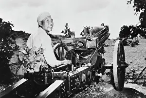 Towed: Chinese soldier smiling proudly by his newly