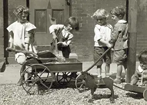 Beals: Chrildren playing with rocks, a wagon and ?