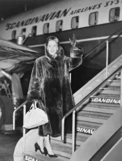 Alternate: Christine Jorgensen, waves as she boards an