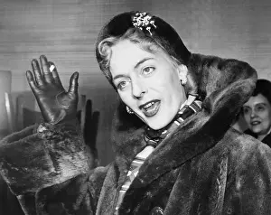 Hormone: Christine Jorgensen, waves to photographers, upon