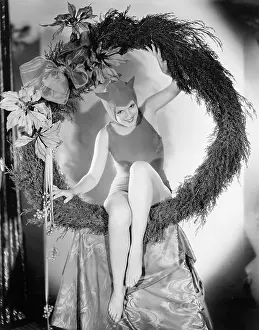 Carnivals: Circling in on the devil, a young woman sits in a wreath