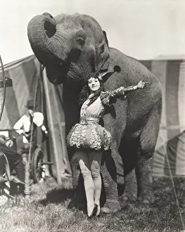 Obedience: Circus performer posing with elephant