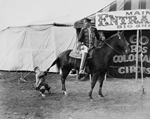Irritated: Circus performer pulling horses tail