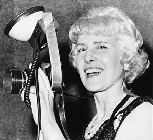 Actively: Clare Booth Luce tries out a photographer's camera