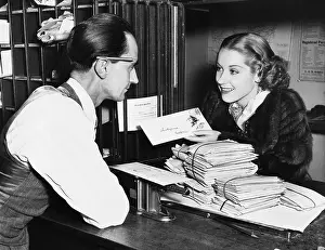 Interactions: Clerk with woman mailing letter