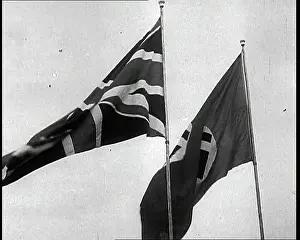 Flagpoles: A Close Up of a German and British Flag Flying