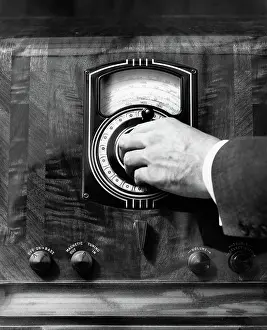 Transmit: Close up man's hand turning radio dial