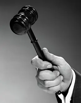 Gavel: Close up man's hand using gavel indoor