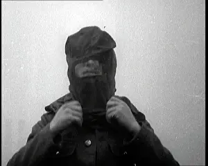 Showcasing: Close Up of a Soldier Putting On His Gas Mask