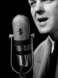 Anchorman: Close-up of man announcer talking into microphone