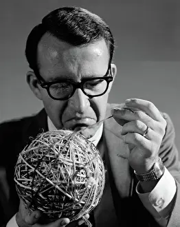 Multi Colored: Close-up of man in suit & glasses pulling strand