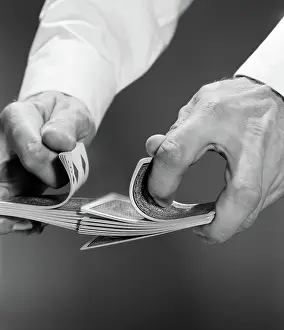 Riffle: Close-up of man's hands shuffling deck of cards