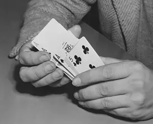 Shuffle: Close-up of man's hands shuffling playing cards