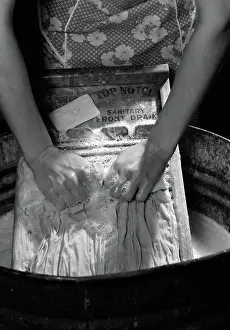 Suds: Close-up of woman's hands scrubbing clothes on