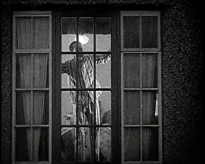 Pyjamas: A Close Up on a Window of a House as the Male