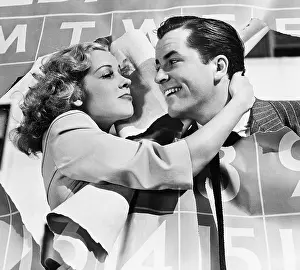 Ripping: Closeup of couple bursting through calendar