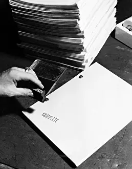 Organize: Closeup of hand stamping movie script