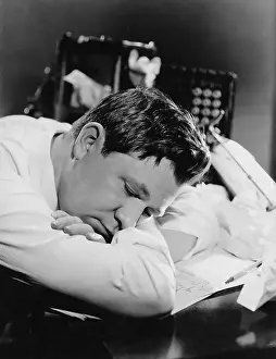 Overworked: Closeup of man sleeping at his desk
