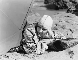 Aroused: Closeup of woman lying on sand