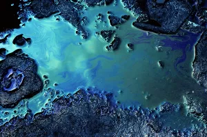 Slick: Clouds in Blue Sky Reflected in Pollution Oil