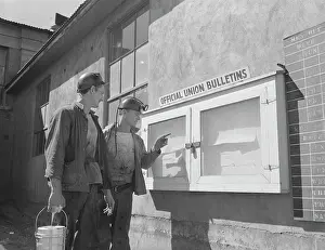 Searching: Coal miners read a notice on the bulletin