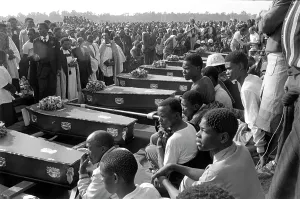Thema: Coffins lined up at gravesites at a mass funeral held