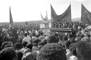 Cradock: One of the coffins moves through the crowd at the funeral
