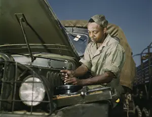 Kentucky: A colored mechanic doing maintenance on Army trucks, 1941