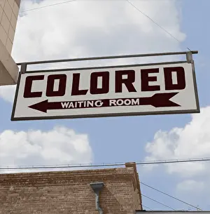 Racially: COLORED WAITING ROOM sign hangs at the Memphis