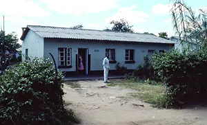 Zanu: Colour photo of couple in front of their home