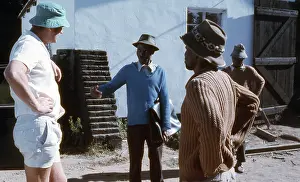 Zanu: Colour photo of farmer talking to labourers in