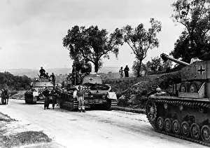 Stops: A column of Panzer IVs stops on a street in southern