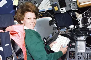 Consults: Commander Eileen Collins consults a checklist ?