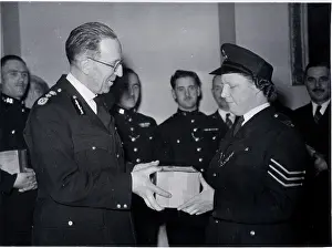 Presenting: Commissioner Scott presenting gift parcel to WPS Layram