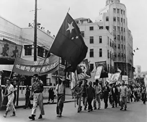 Guangdong: Communist marchers parade along the Pearl River