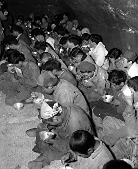 Disarmed: Communist soldiers are fed in the POW stockade