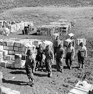 Establishment: Compo ration dump and men carrying more supplies