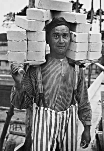 Prewar: A concentration camp internee carrying bricks for constructi