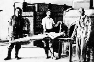 Shocking: Concentration camp internees at Dachau cremating the body of